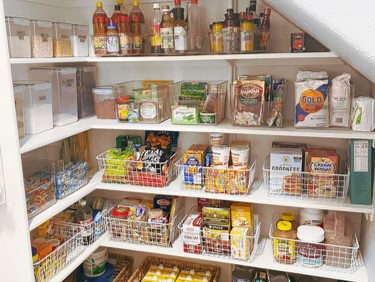 After photo of beautifully organized under the staircase pantry. ClutterFree PHD personal home detailing services in Boerne TX, San Antonio, Hill Country Texas, and virtual services across the USA.