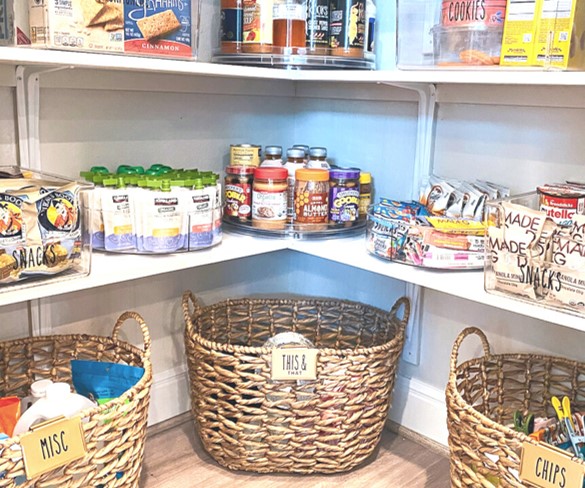 Organized pantry closet with baskets and other home organization storage. A light and neutral organized pantry.