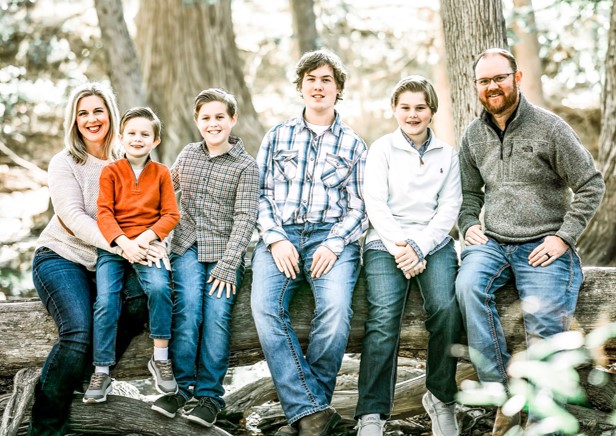 Founder of ClutterFree PHD, (a home organziation company) Kelly Watts with her family of four boys and her husband.